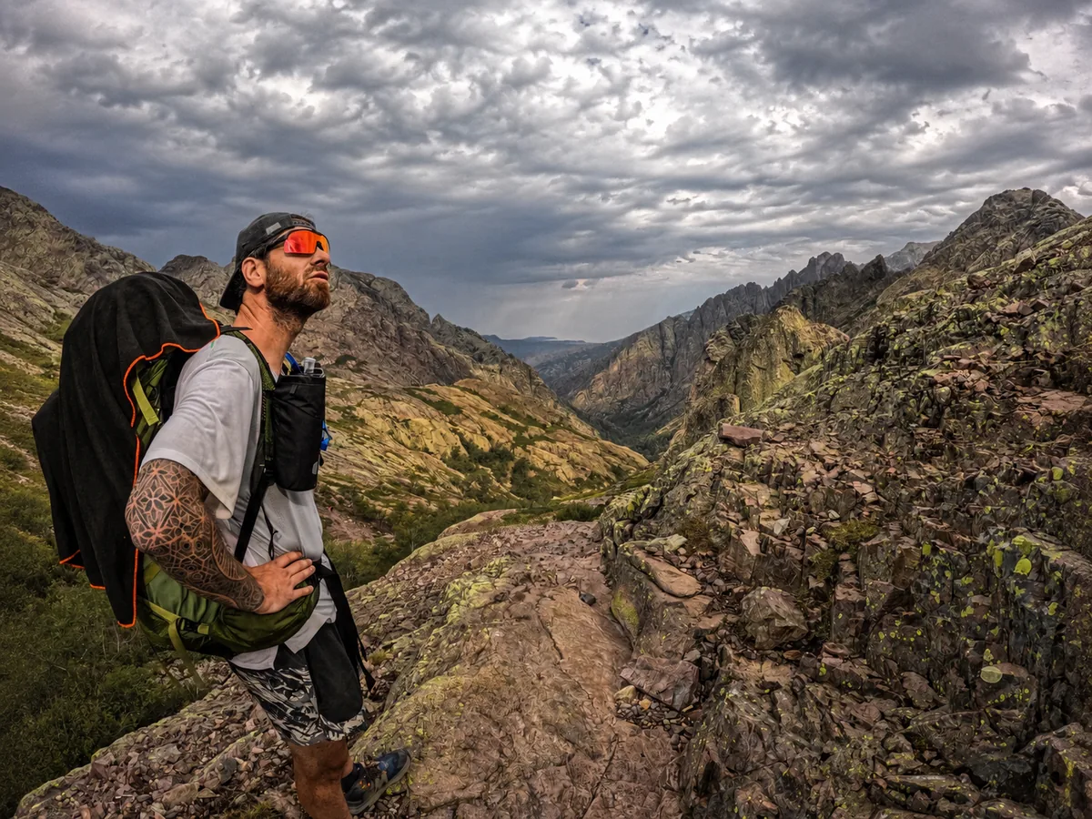 Hiker under a stormy sky